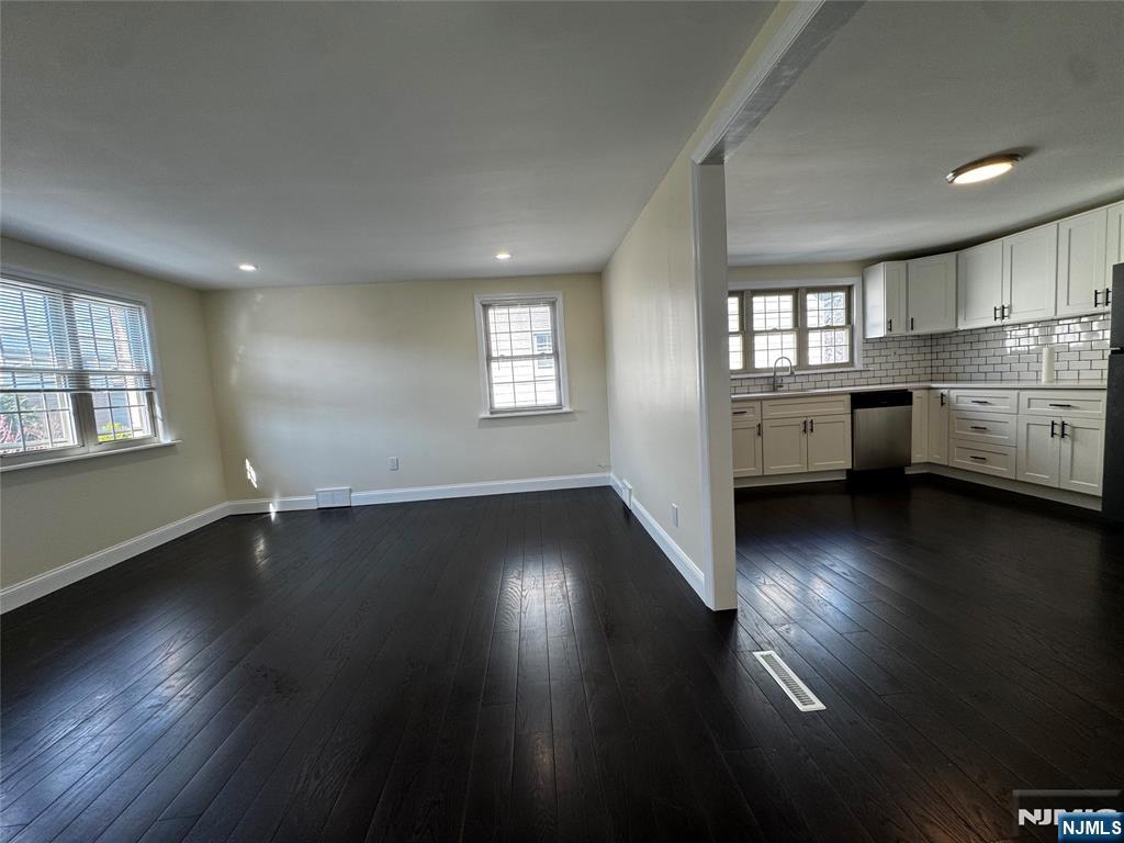 158 A Rutherford Place North Arlington, NJ 07031 - Photo 3 of 13 an empty room with wooden floor and windows