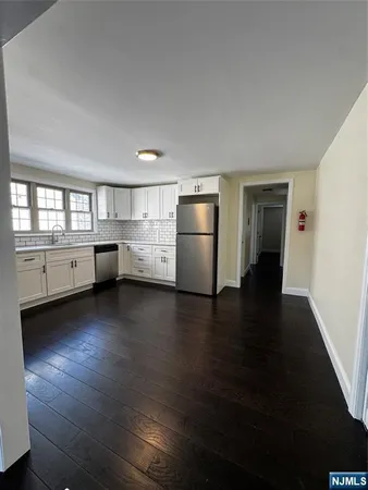 a kitchen with refrigerator and window