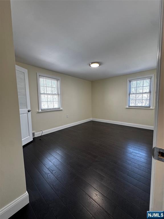 158 A Rutherford Place North Arlington, NJ 07031 - Photo 10 of 13 an empty room with wooden floor and windows