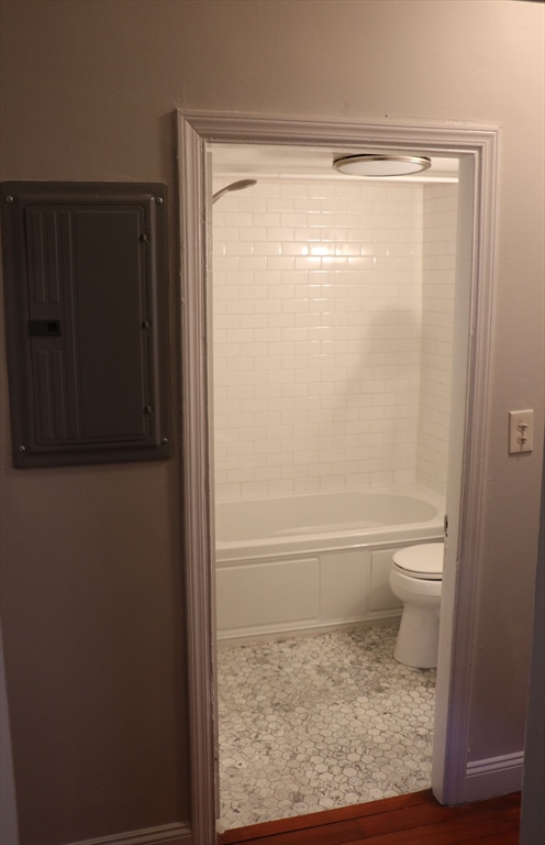 320 Warren Street, Unit 2 Boston, MA 02119 - Photo 12 of 22 a bathroom with a glass shower door