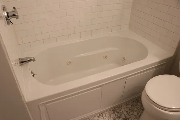 a bathroom with a bathtub and toilet