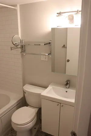 a white toilet sitting next to a bathroom sink