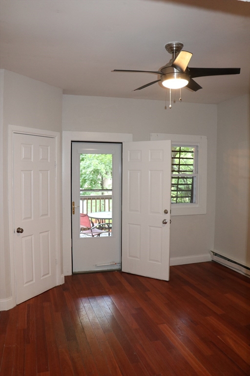 320 Warren Street, Unit 2 Boston, MA 02119 - Photo 19 of 22 wooden floor in an empty room with a window