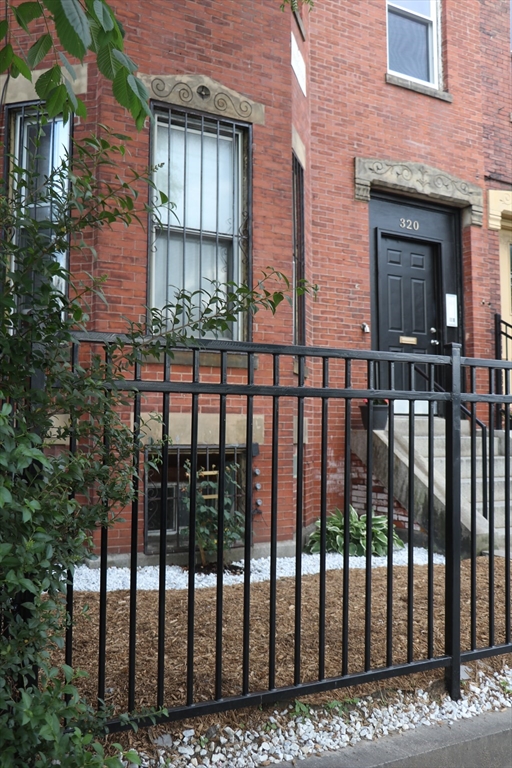 320 Warren Street, Unit 2 Boston, MA 02119 - Photo 2 of 22 a view of a brick house with a street