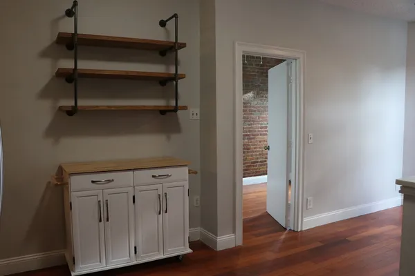 a view of walk in closet with empty racks