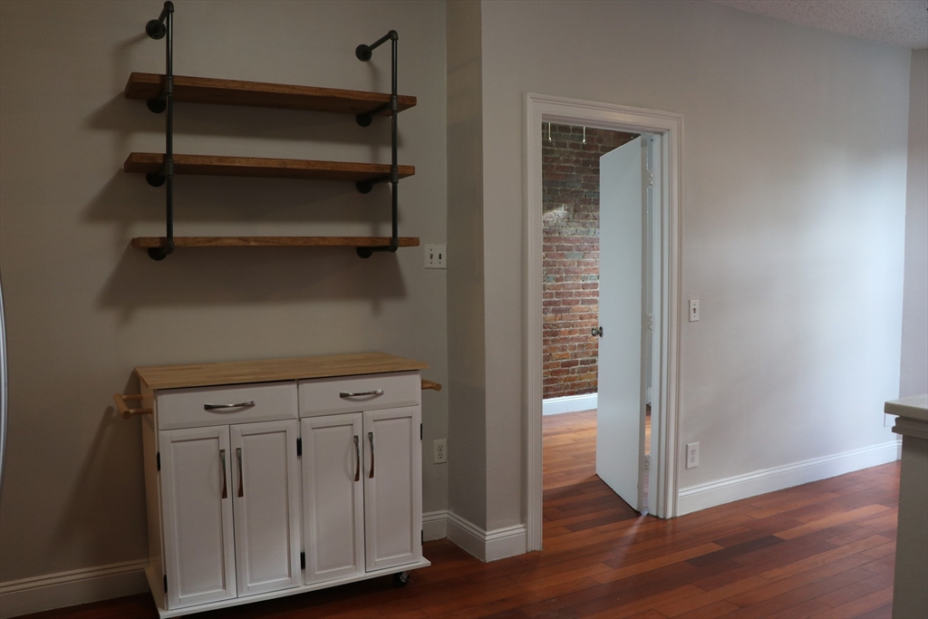 320 Warren Street, Unit 2 Boston, MA 02119 - Photo 5 of 22 a view of walk in closet with empty racks