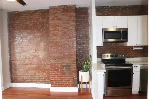 a kitchen with a sink stove and microwave