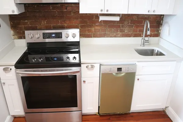 a close view of a stove top oven and sitting space