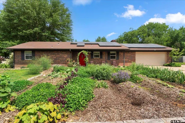 a front view of house with yard and trees