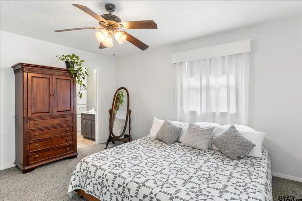 a bedroom with a bed dresser and a window