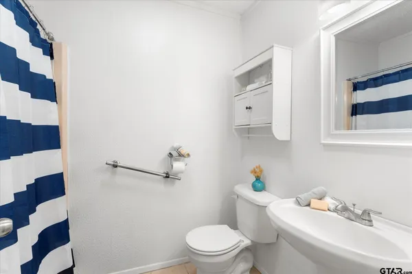 a white toilet sitting next to a bathroom sink