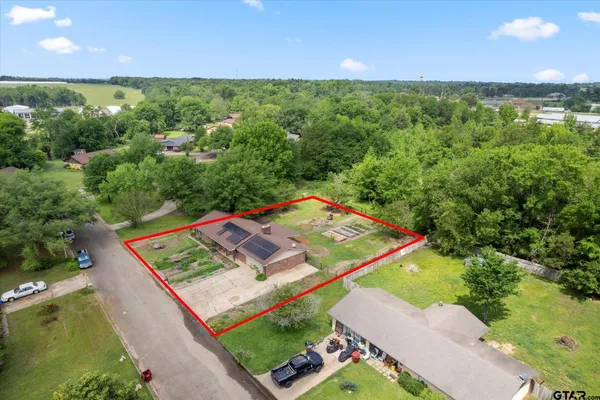 an aerial view of a house with a yard