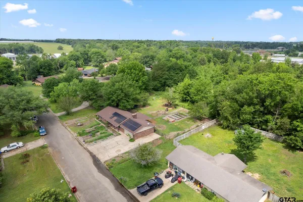 an aerial view of residential houses with outdoor space and river