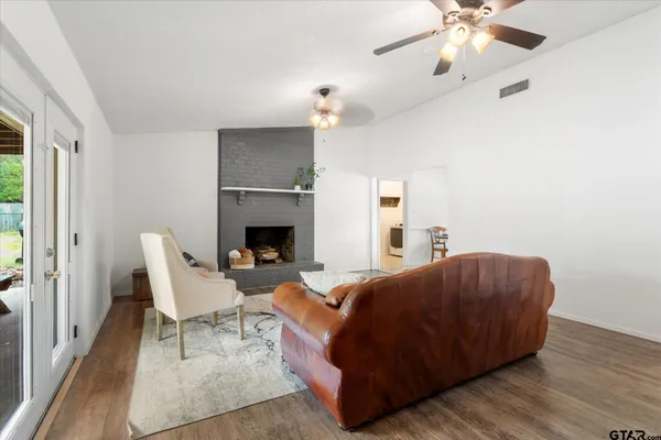 a living room with furniture and a fireplace