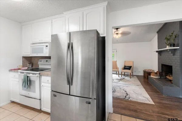 a kitchen with stainless steel appliances a refrigerator stove and sink