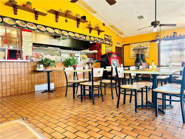 a living room with furniture a rug and a floor to ceiling window