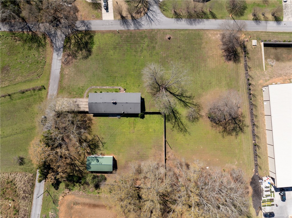 300 Green Street Williamston, SC 29697 - Photo 33 of 47 An aerial perspective showcases a vast, verdant property featuring a main residence and a detached shed.