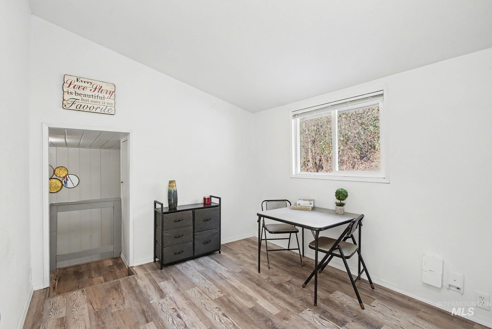 150 Elm Street Orofino, ID 83544 - Photo 17 of 36 Bright interior room featuring wood-finish flooring, white walls, and a large window