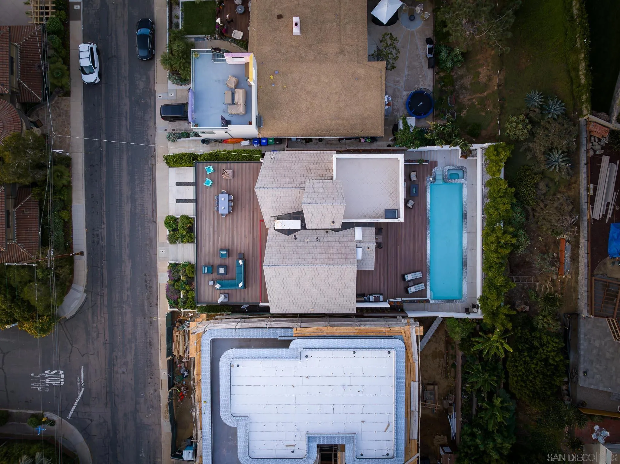 949 Cornish Drive San Diego, CA 92107 - Photo 16 of 28 an aerial view of a house with a garden and parking