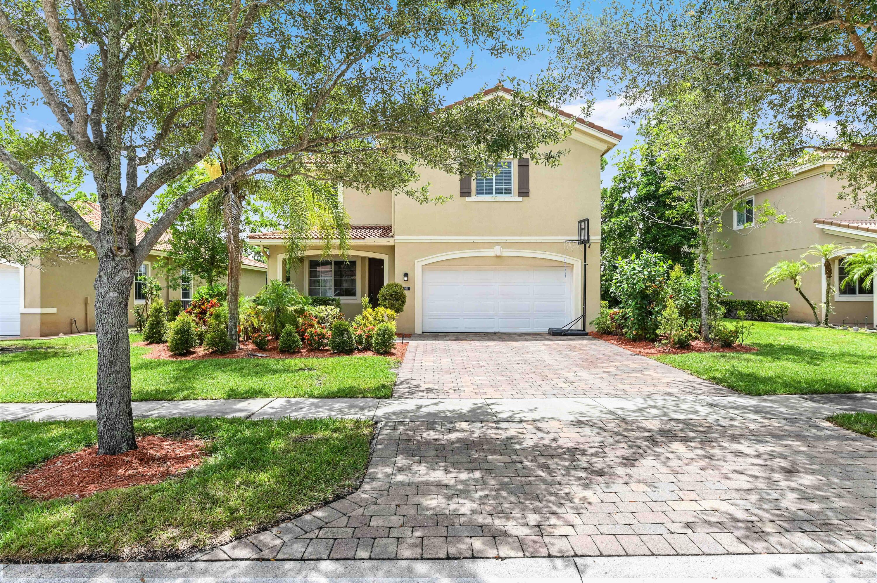 a front view of a house with a yard and a garage