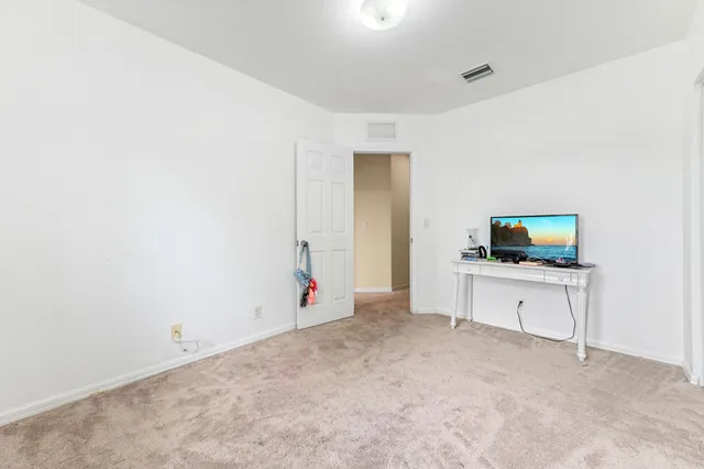 a view of a room with furniture and a ceiling fan