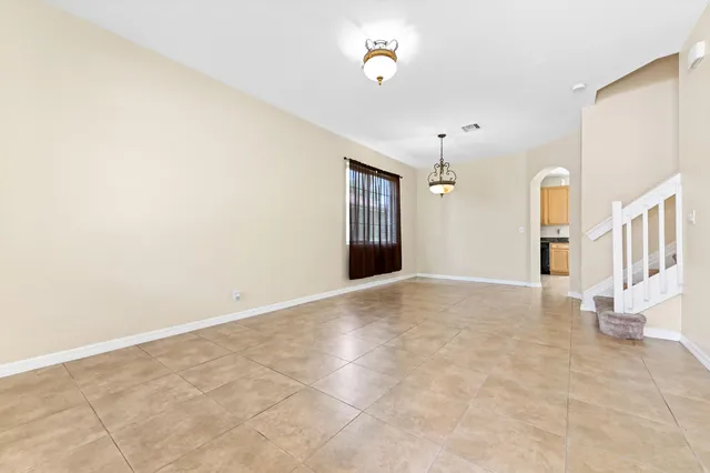 a view of a hallway with wooden floor and a window
