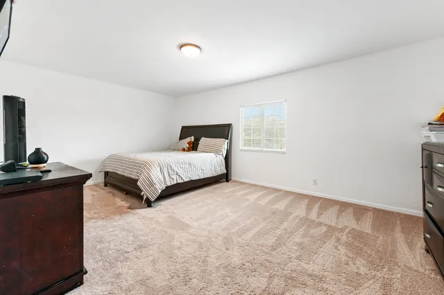 a bedroom with a bed and a television