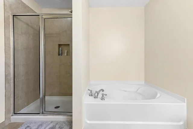 a bed room with a dresser and a mirror