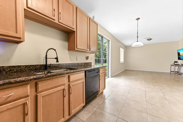 a kitchen with a sink cabinets and window