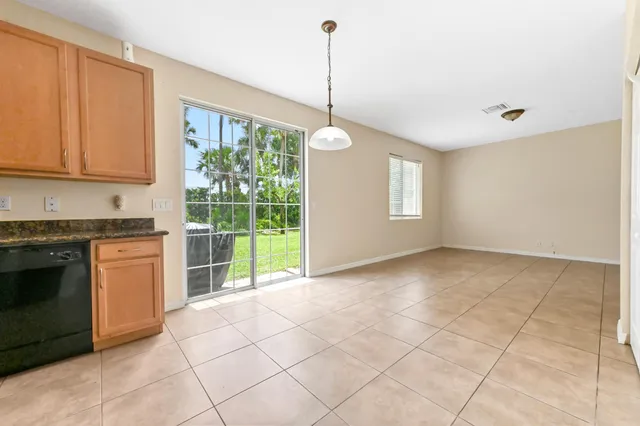 a view of a kitchen with furniture and stainless steel appliances