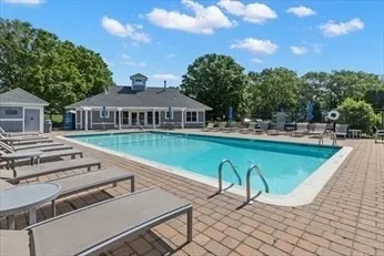 a view of a chairs and table in patio with a lake view