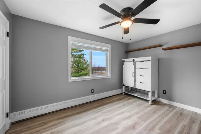 a view of room with window and ceiling fan