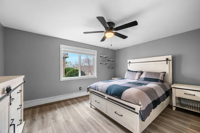 a large bedroom with a bed and a window