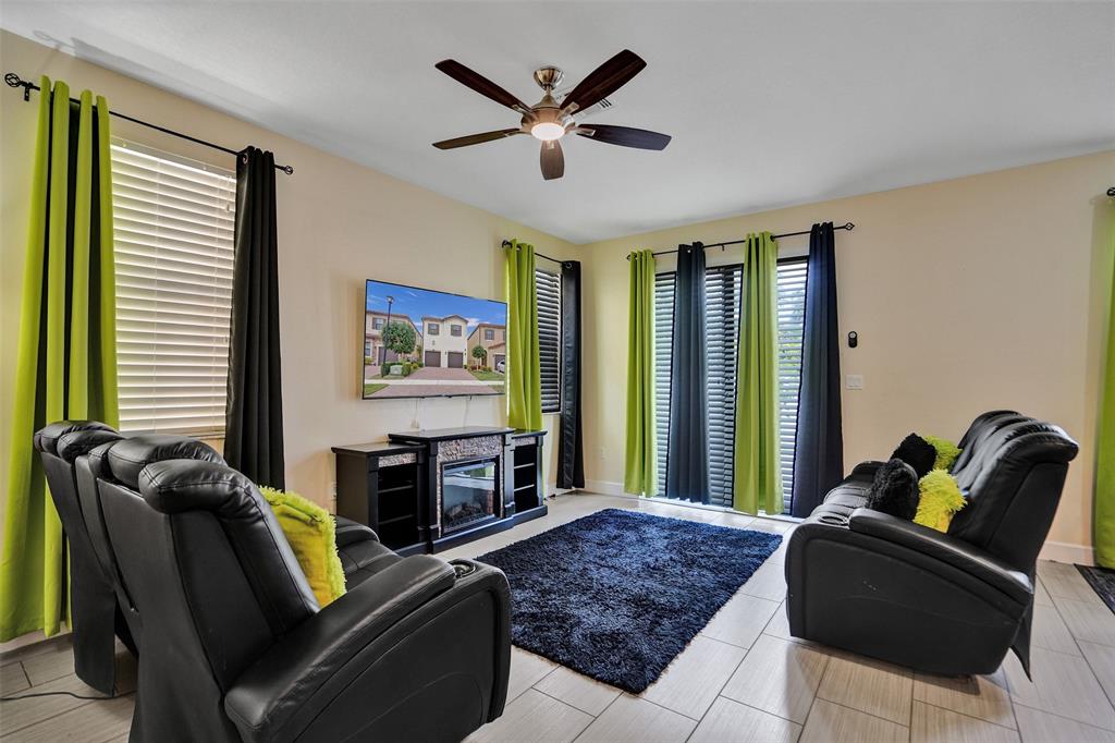 4875 Northwest 55th Place Tamarac, FL 33319 - Photo 11 of 44 a living room with furniture and a large window