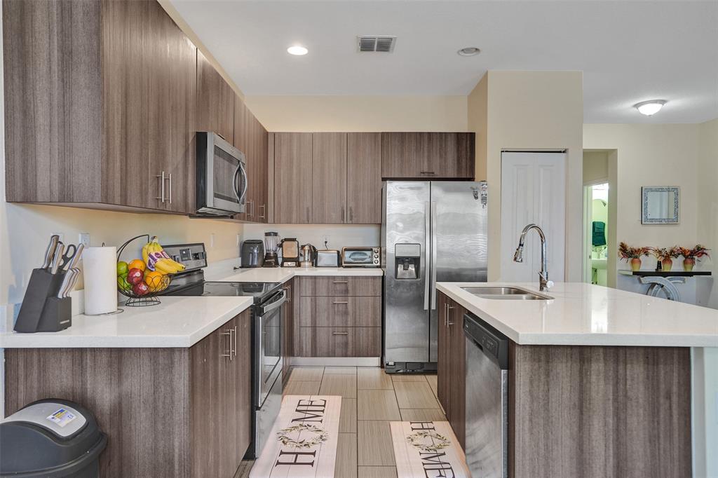 4875 Northwest 55th Place Tamarac, FL 33319 - Photo 16 of 44 a kitchen with refrigerator and cabinets