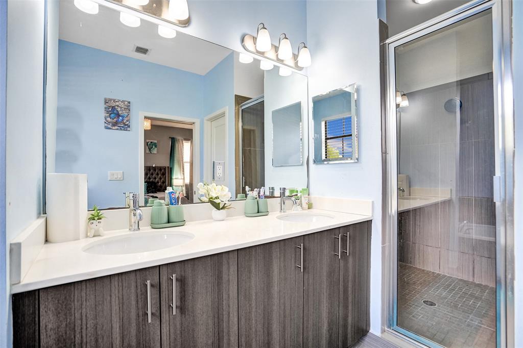 4875 Northwest 55th Place Tamarac, FL 33319 - Photo 26 of 44 a bathroom with a sink double vanity and a mirror