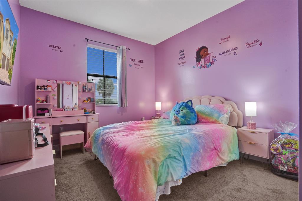 4875 Northwest 55th Place Tamarac, FL 33319 - Photo 30 of 44 a bedroom with a bed and a table