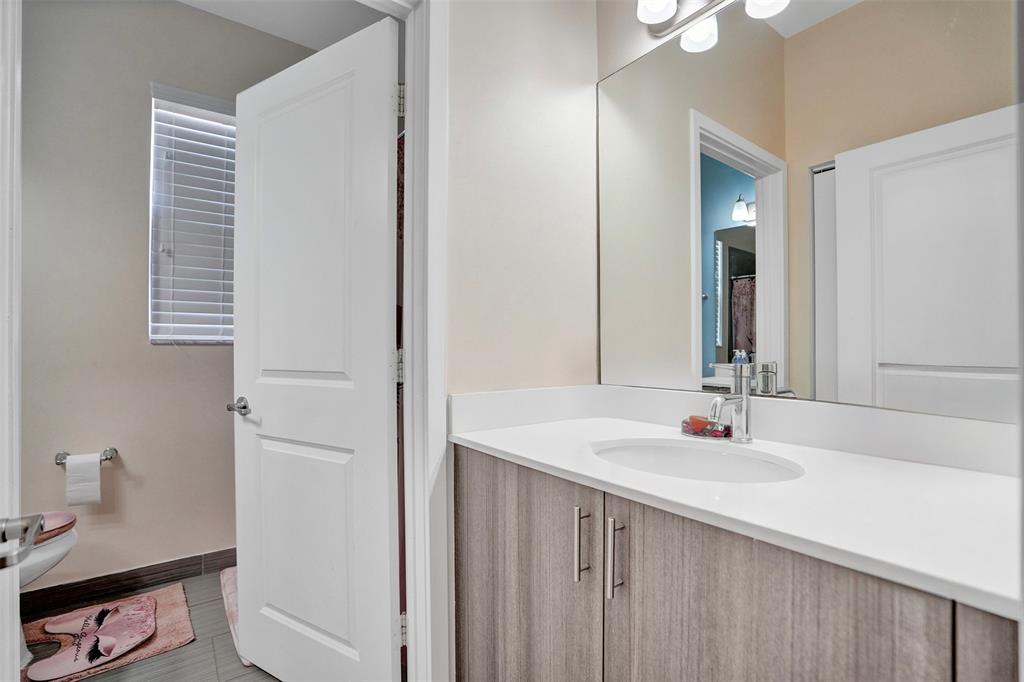 4875 Northwest 55th Place Tamarac, FL 33319 - Photo 34 of 44 a bathroom with a sink vanity and a mirror