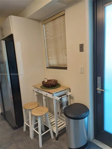 a view of a room with a table and chairs