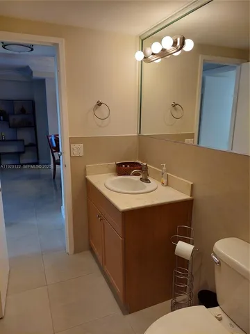 a bathroom with a sink a toilet and a mirror