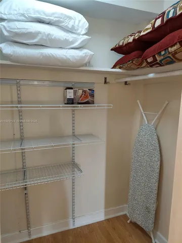 a view of a closet with wooden racks