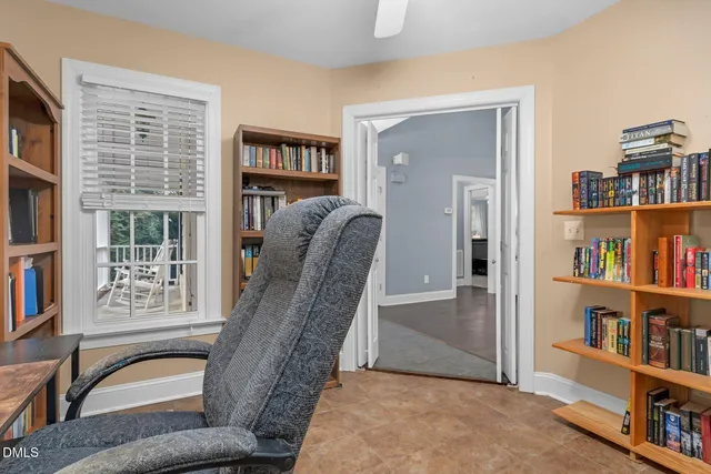 a dining room with furniture a chandelier and wooden floor