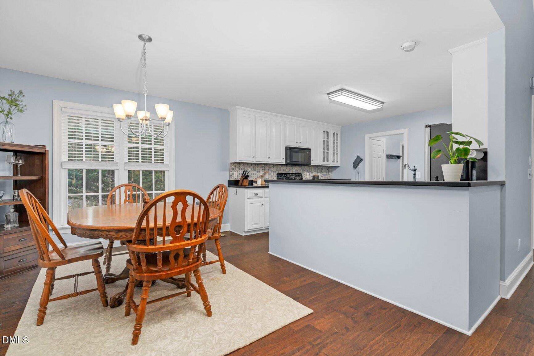 259 Sacred Fire Road Louisburg, NC 27549 - Photo 13 of 35 a dining room with furniture a window and appliances