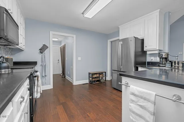 a kitchen with stainless steel appliances a refrigerator sink and microwave