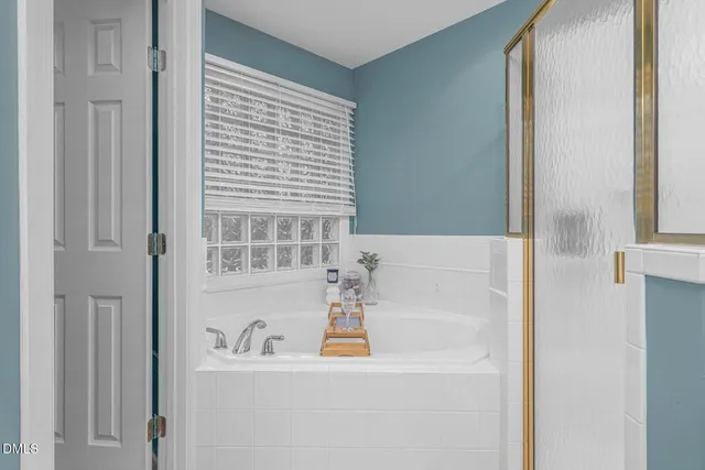 a bathroom with a bathtub and a shower