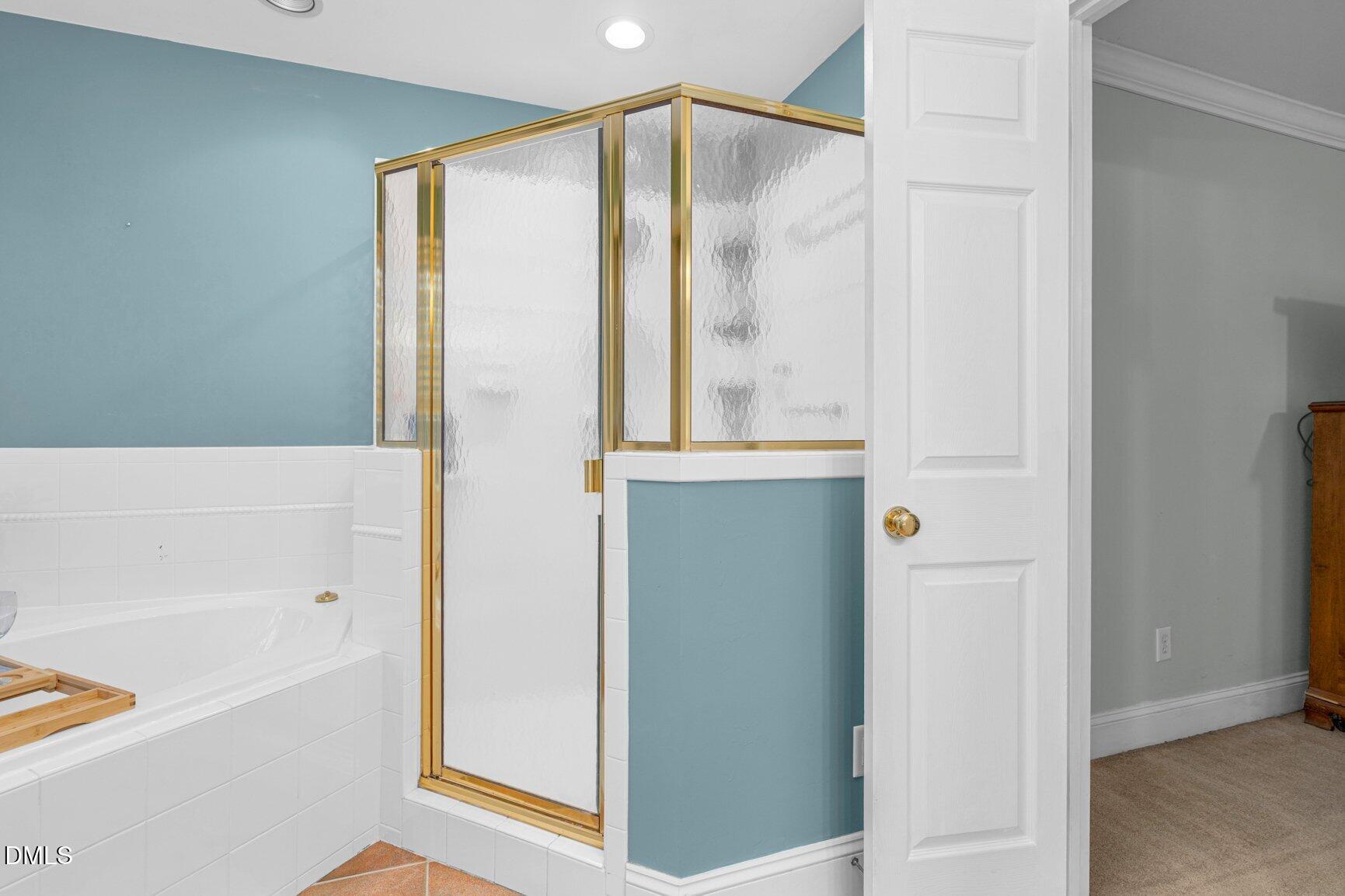 259 Sacred Fire Road Louisburg, NC 27549 - Photo 27 of 35 a bathroom with a bathtub and a shower