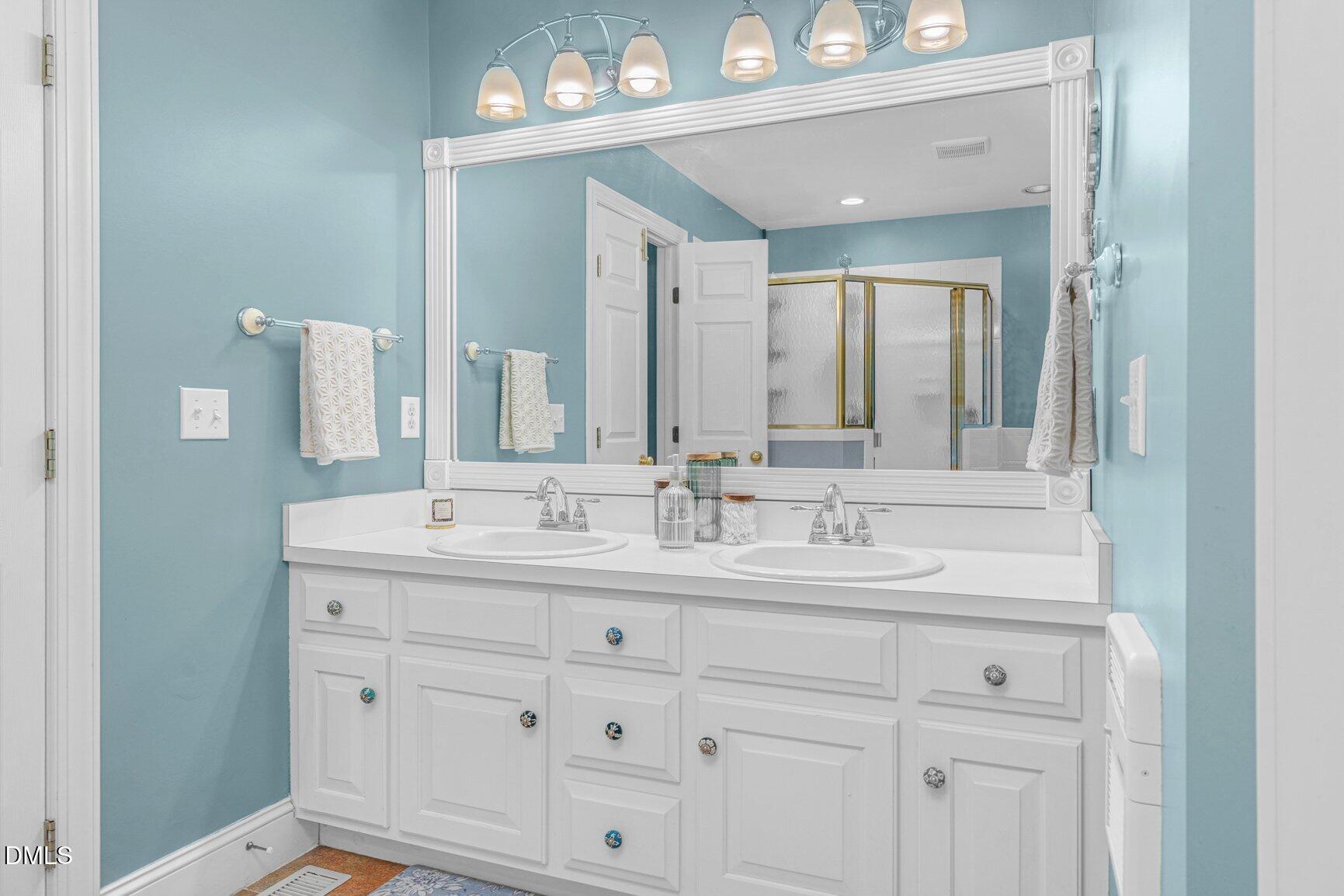 259 Sacred Fire Road Louisburg, NC 27549 - Photo 28 of 35 a bathroom with a sink vanity and mirror