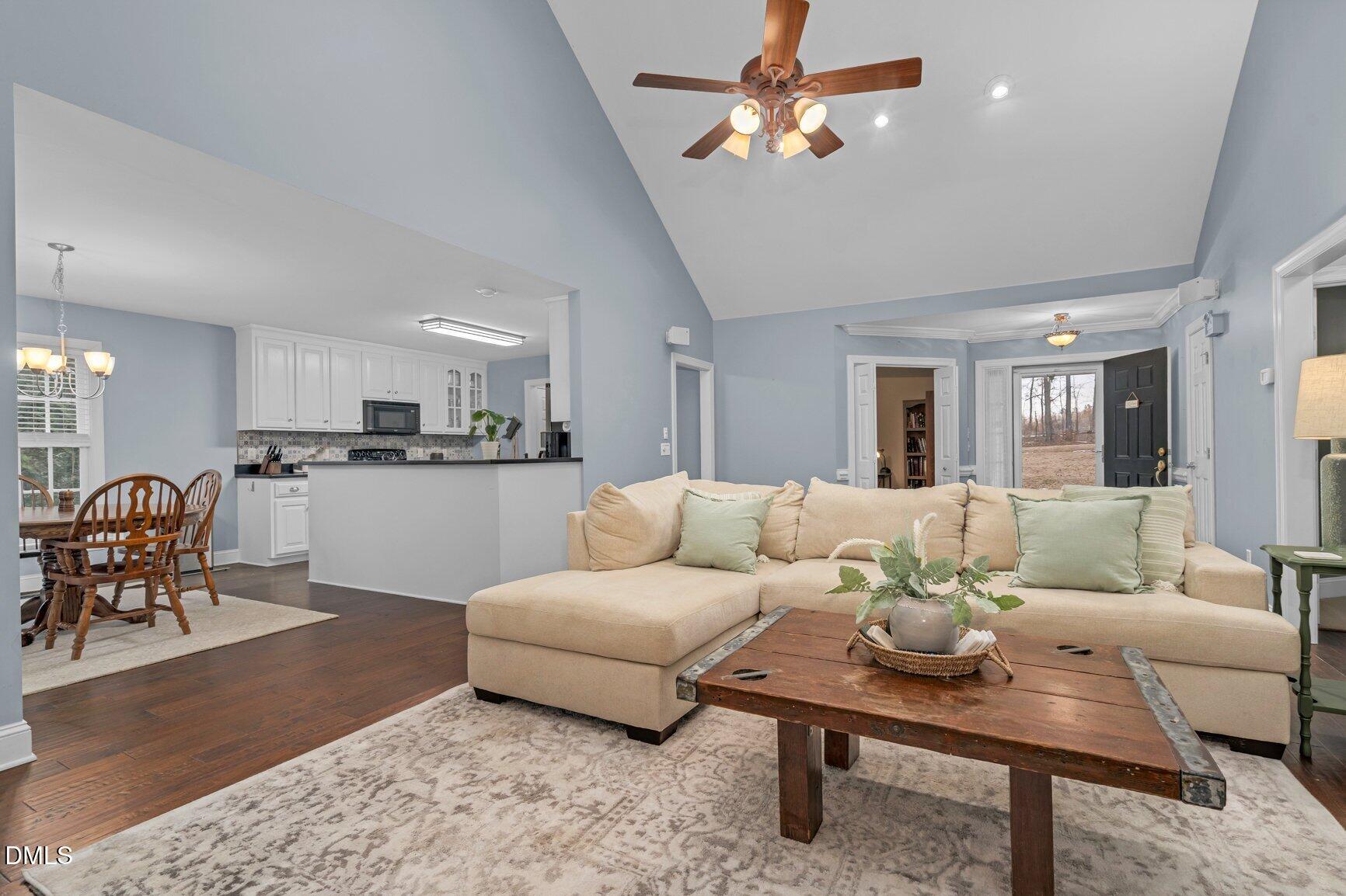 259 Sacred Fire Road Louisburg, NC 27549 - Photo 8 of 35 a living room with furniture kitchen view and a dining table