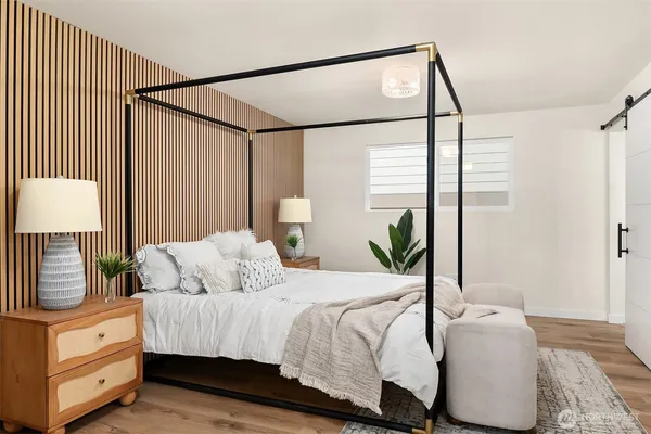 a bedroom with a bed and a night stand