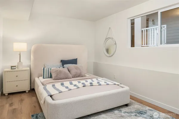 a bedroom with a large bed and a chandelier